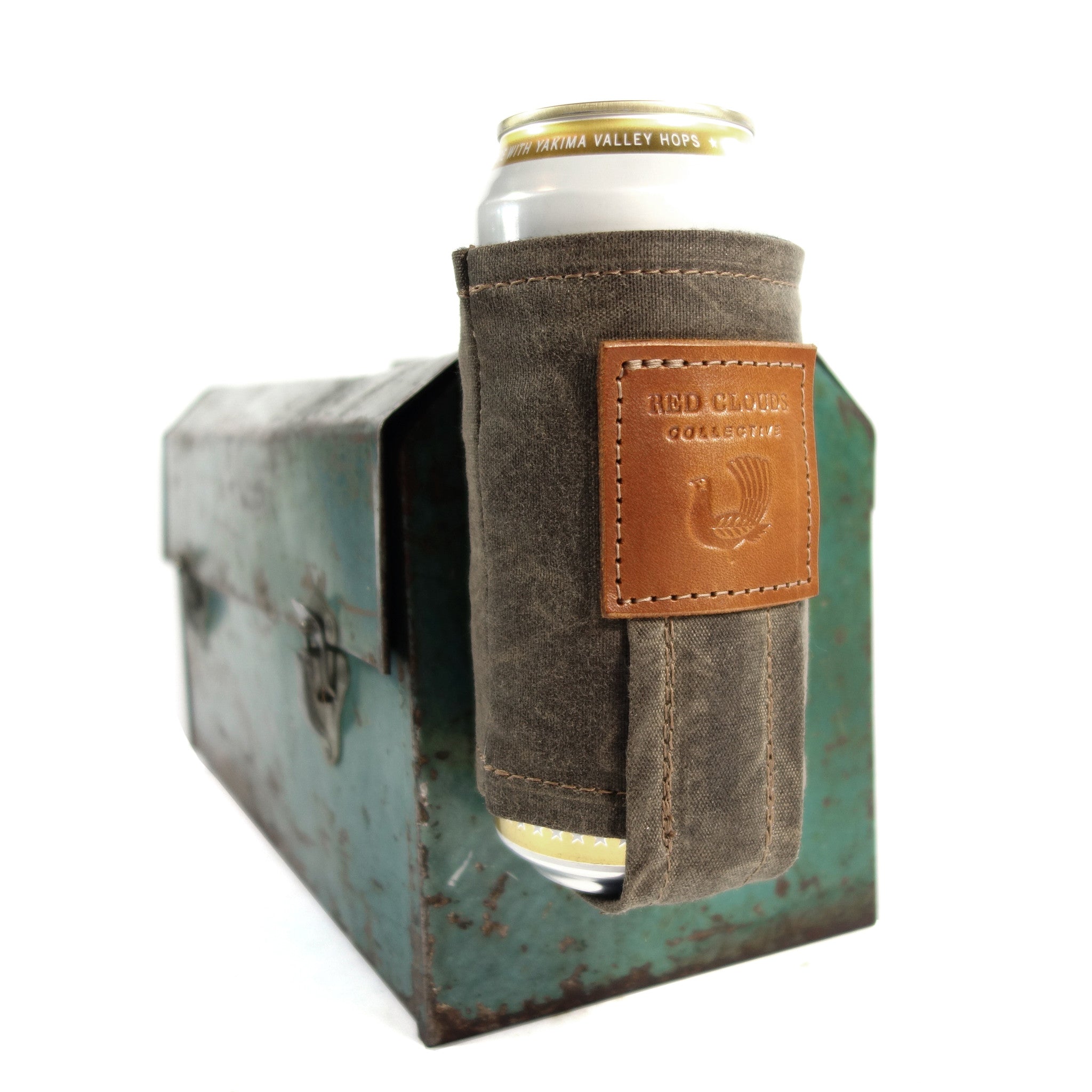 Magnetic Koozie, waxed canvas koozie, leather koozie, rare earth magnets, beer koozie, tallboy koozie, red clouds koozie, This is not your normal koozie. It uses very strong, rare earth magnets to hold the weight of your full beverage attached to the fridge, stove, your car or any other metal surface while you are working or playing. A clever back loop also lets you attach a string and wear the koozie around your neck.